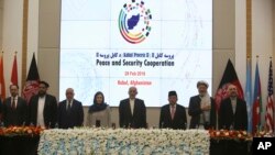 Afghan President Ashraf Ghani, center, and delegates stand for the national anthem during the second Kabul Process conference at the Presidential Palace in Kabul, Feb. 28, 2018. 