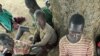 Children suffering from nodding disease gather in Akoya-Lamin Omony village in Gulu district, 384 kilometers north of Uganda's capital of Kampala, February 19, 2012.