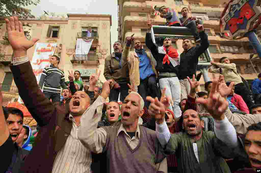 Protesters shout slogans during a demonstration against the Egyptian military council in Tahrir square in Cairo, November 27, 2011. (Reuters)