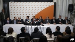 From left: Lebanese Ministers Ali Abdallah, Mohammed Fneish, Abraham Dedeyan, Hussein Hajj Hassan, Jibran Bassil, Mohammed Jawad Khalife, Fady Abboud, Charbel Nahhas, Youssef Saade and Ali Shami hold a press conference to announce their resignation in the