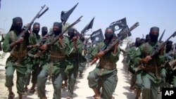FILE - Al-Shabab fighters march with their weapons during military exercises on the outskirts of Mogadishu, Somalia, Feb. 17, 2011. U.S. airstrikes killed 11 al-Shabab extremists Dec. 19, 2018, outside Somalia's capital, the military said in a statement. 