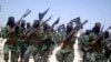 FILE - Al-Shabab fighters march with their weapons during military exercises on the outskirts of Mogadishu, Somalia, Feb. 17, 2011. The U.S. military said, July 9, 2023, it has conducted three new airstrikes against al-Shabab fighters in the Lower Juba region.