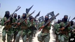 FILE - Al-Shabab fighters march with their weapons during military exercises on the outskirts of Mogadishu, Somalia, Feb. 17, 2011. The U.S. military said, July 9, 2023, it has conducted three new airstrikes against al-Shabab fighters in the Lower Juba region.