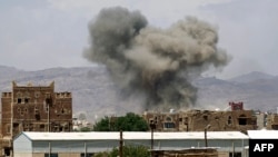 Smoke billows from buildings after reported airstrikes by the Saudi-led coalition on arms warehouses at Al-Dailami air base, north of the capital Sana'a, Sept. 29, 2015. 