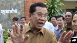Cambodian Prime Minister Hun Sen gestures after casting his ballot in local elections at Ta Khmau town, in Kandal province.