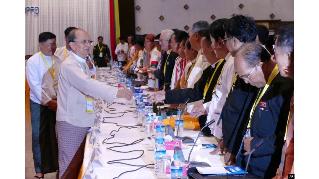 Myanmar President Thein Sein, front left, greets representatives of political parties during a meeting at Yangon region government office in Yangon, Myanmar, Nov. 15, 2015.