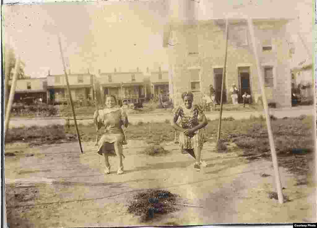 Children Arnetta and Catherine are seen playing on swings, in Wheaton Park, Hagerstown, Maryland, in the 1930s. (Courtesy of Wendi Perry, Curator of Doleman Black Heritage Museum)