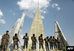 FILE - Members of Syrian Democratic Forces (SDF) attend the funeral of eight fellow fighters who died during an assault against the Islamic State (IS) group in the town of Manbij, in the Syrian Kurdish town of Kobane (aka Ain al-Arab) on June 24, 2016.