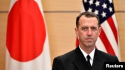 FILE - Admiral John Richardson, chief of U.S. Naval Operations, waits for Japan's Prime Minister Shinzo Abe before their meeting at the prime minister's official residence in Tokyo, Dec. 18, 2017. 