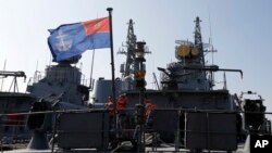 FILE - Montenegrin sailors stand at the frigate "Kotor" in the harbor of Bar, Montenegro, March 15, 2017. The tiny Balkan country is formally becoming NATO’s 29th member Monday.