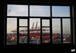 Cranes of the port of El Callao, Peru, are seen through a window, Nov. 17, 2016. Leaders of the Asia-Pacific Economic Cooperation will meet in Lima Nov. 19-20 to discuss the future of international trade policies, growth and improvement of life conditions for more than a third of the world's population.