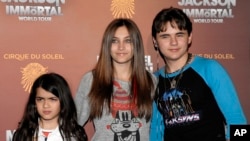 FILE - This Jan. 27, 2012 file photo shows, from left, Blanket Jackson, Paris Jackson, and Prince Michael Jackson at the opening night of the Michael Jackson The Immortal World Tour in Los Angeles.