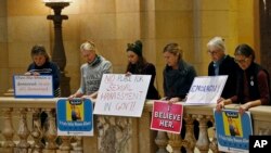 FILE - Women rally at the State Capitol in St. Paul, Minnesota, in response to a tide of sexual harassment allegations, Nov. 17, 2017.