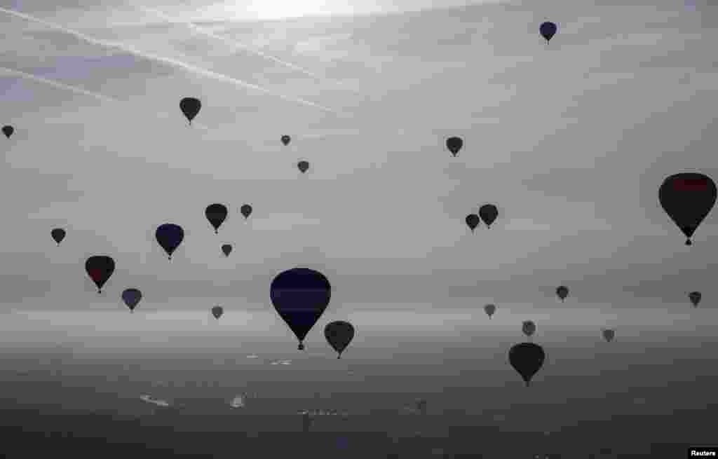 Balloons rise into the sky at the International Balloon Fiesta near Bristol in western England.