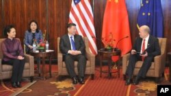 Chinese President Xi Jinping, center, listens to Alaska Governor Bill Walker at a meeting Friday April 7, 2017, in Anchorage, Alaska. At left is Chinese first lady Peng Liyuan. Xi requested time with Gov. Bill Walker Friday night as the Chinese delegation's plane made a refueling stop in Alaska's largest city following meetings with President Donald Trump in Florida. 