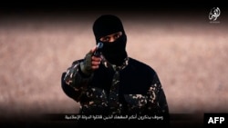 FILE - An image taken from a video published by the media branch of the Islamic State (IS) group on Jan. 3, 2016, purportedly shows an IS fighter at an undisclosed location before executing five men from the Syrian city of Raqa. 