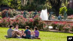 FILE - Students are seen sitting on a lawn on the campus of Florida State University in Tallahassee, Florida, April 30, 2015. Increasing numbers of students are now taking a "gap year" before enrolling in colleges.