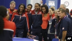 First lady Michelle Obama poses with members of Team USA, 2012 Summer Olympics, London, July 27, 2012.