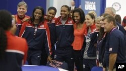 First lady Michelle Obama poses with members of Team USA, 2012 Summer Olympics, London, July 27, 2012.