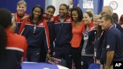 First lady Michelle Obama poses with members of Team USA, 2012 Summer Olympics, London, July 27, 2012.