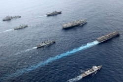British, Canadian and Japanese vessels sail together in the Pacific Ocean on Septemebr 2021. The U.S. and its allies are becoming assertive in their approach toward a rising China. (UK Ministry of Defence via AP)