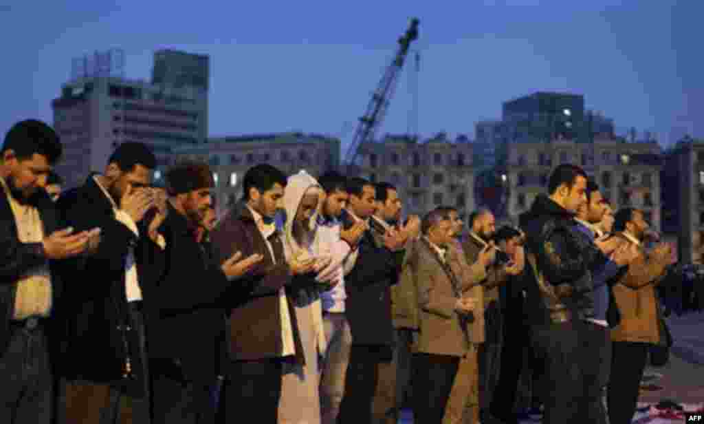 Muslim anti-government protesters make their prayers at dusk at the continuing demonstration in Tahrir square in downtown Cairo, Egypt, Tuesday, Feb. 1, 2011. More than a quarter-million people flooded into the heart of Cairo Tuesday, filling the city's m