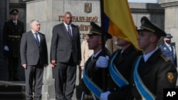 Ukrainian Defense Minister Andriy Taran, left, and U.S. Defense Secretary Lloyd Austin review the honor guard during a welcome ceremony ahead of their meeting in Kyiv, Ukraine, Oct. 19, 2021. 