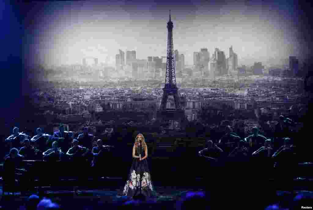 Celine Dion performs "Hymne a l'amour" in honor of the victims of the recent Paris attacks as an image of the Eiffel Tower is shown in the background during the 2015 American Music Awards in Los Angeles, California, Nov. 22, 2015.