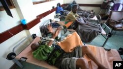 FILE - Cholera patients lie in beds in Budiriro clinic in Harare, Zimbabwe.