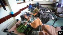 FILE - Cholera patients lie in beds in Budiriro clinic in Harare, Zimbabwe. A cholera emergency has been declared in Harare after 20 people have died. 