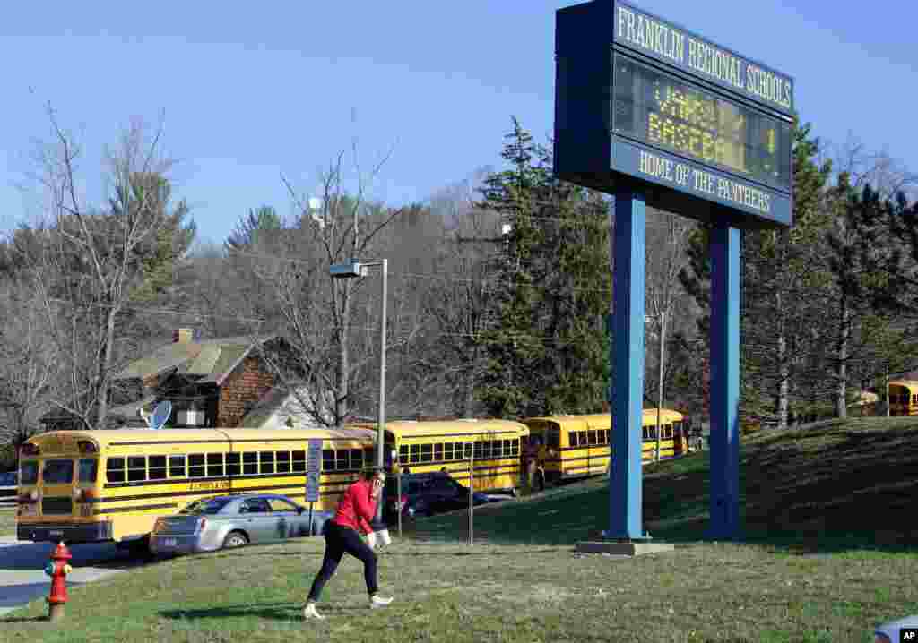 A woman walks onto the campus of the Franklin Regional School District where several people were stabbed at Franklin Regional High School, Murrysville, Pennsylvania, April 9, 2014. 