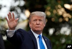 FILE - President Donald Trump waves as he walks to Marine One, July 12, 2017, in Washington.