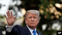 President Donald Trump waves as he walks to Marine One, July 12, 2017, in Washington, as he heads to Paris for Bastille Day. 