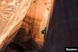 Rock climber David Rozul makes an ascent in Indian Creek, an area that attracts outdoor recreationists from around the world to Bears Ears National Monument, Utah, Oct. 29, 2017.