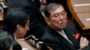 Japanese Prime Minister Shigeru Ishiba, right, speaks with other lawmakers prior to a Diet session at the Upper House of the Parliament, Oct. 4, 2024, in Tokyo. 