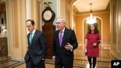 Pemimpin Mayoritas Senat Mitch McConnell (tengah) berjalan bersama Senator Pat Toomey (kiri), keduanya dari Partai Republik, di Gedung Kongres, Washington, DC. (Foto: Dok)