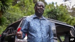 Kenya's opposition leader Raila Odinga speaks next to one of his vehicles he says was struck by a teargas canister fired by riot police, at his home in Nairobi, Kenya, March 31, 2023.
