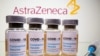 FILE PHOTO: Vials and medical syringe are seen in front of AstraZeneca logo in this illustration