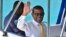 File - Maldives former President Mohamed Nasheed waves from a boat as he is taken back to Dhoonidhoo prison after a court dismissed his appeal against his arrest in Male, Maldives, March 2015.