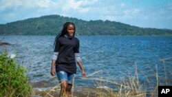 FILE: Ugandan climate activist Vanessa Nakate walks along the shore of Lake Victoria on the outskirts of Kampala, Uganda, Dec. 6, 2021.