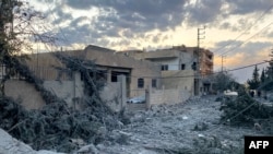 People inspect the damage at the site of an Israeli airstrike that targeted the eastern village of Al-Kayal near Baalbek in the Bekaa valley on Oct. 31, 2024, amid the ongoing war between Israel and Hezbollah. 