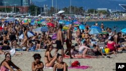 People enjoy the beach in Barcelona, Spain, July 18, 2020. 