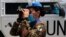 FILE - An Italian UN peacekeeping soldier looks through binoculars on a road that leads to a UN post along the border known as Ras Naqoura where Lebanese and Israeli delegations are meeting, in Naqoura, Lebanon, May 4, 2021.