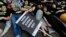 FILE - Supporters stage a 'Die-In' to mark World Hepatitis Day at Piccadilly Circus in London.