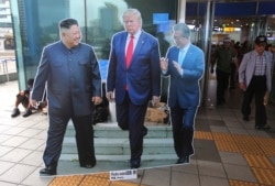 FILE - Cut-out photos of North Korean leader Kim Jong Un, left, U.S. President Donald Trump, and South Korean President Moon Jae-in, right, are displayed in Seoul, South Korea, August 15, 2019.