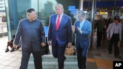 FILE - Cut-out photos of North Korean leader Kim Jong Un, left, U.S. President Donald Trump, and South Korean President Moon Jae-in, right, are displayed in Seoul, South Korea, Aug. 15, 2019. 