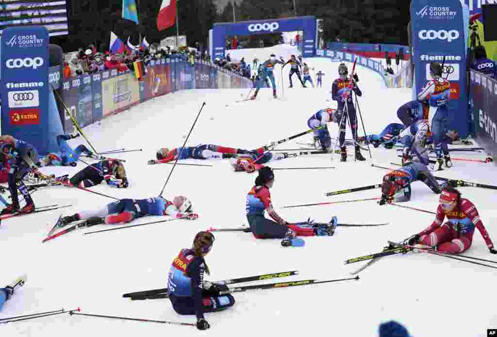 Participants recover at the finish line during the Women&#39;s Mass Start Free 10km event at the Tour de Ski in Val di Fiemme, Trento, Italy.