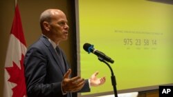 Jim Nickel, the deputy chief of mission for the Canadian Embassy in China, speaks as a countdown clock shows the length of time that Canadian citizen Michael Spavor has been detained in China at the Canadian Embassy in Beijing, Aug. 11, 2021. 