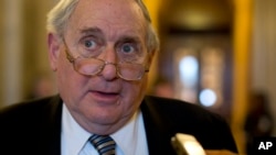 FILE - Senate Armed Services Committee Chairman Sen. Carl Levin, D-Mich. speaks with reporters on Capitol Hill.