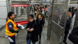 Transit workers disinfect a subway station while people exit the station in the Manhattan borough of New York City, March 4, 2020.